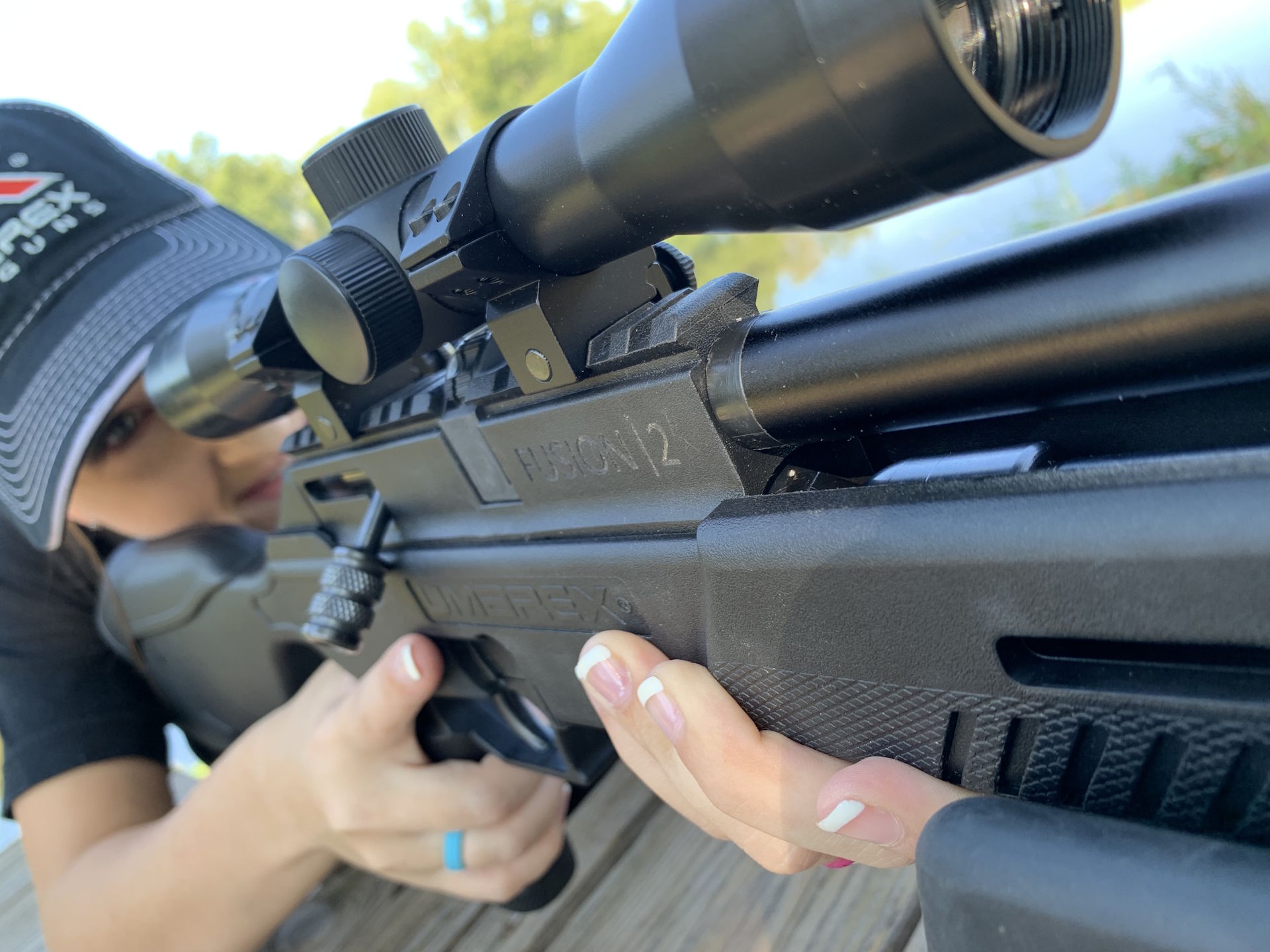 Woman shooting an umarex air rifle from a bench